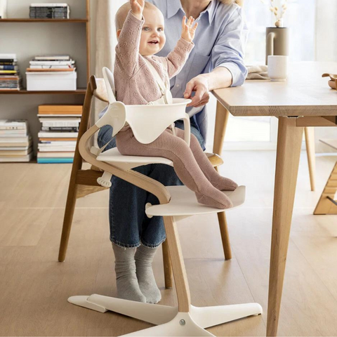 Stokke Nomi Baby Set with Baby Set sitting at table